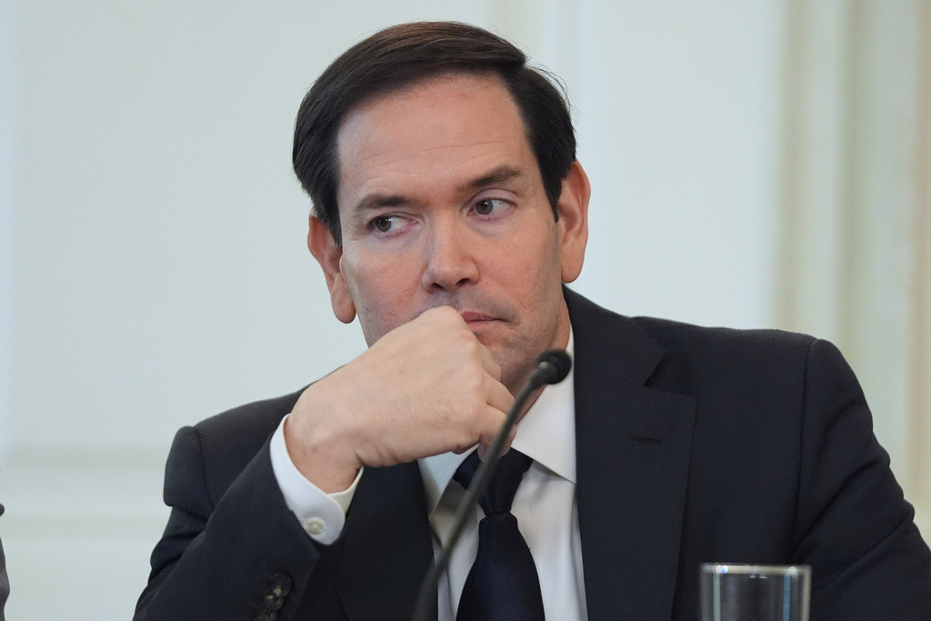 Secretary of State Marco Rubio listens before interrupting President Donald Trump during a roundtable meeting on antifa in the State Dining Room at the White House, Wednesday, Oct. 8, 2025, in Washington. (AP Photo/Evan Vucci)