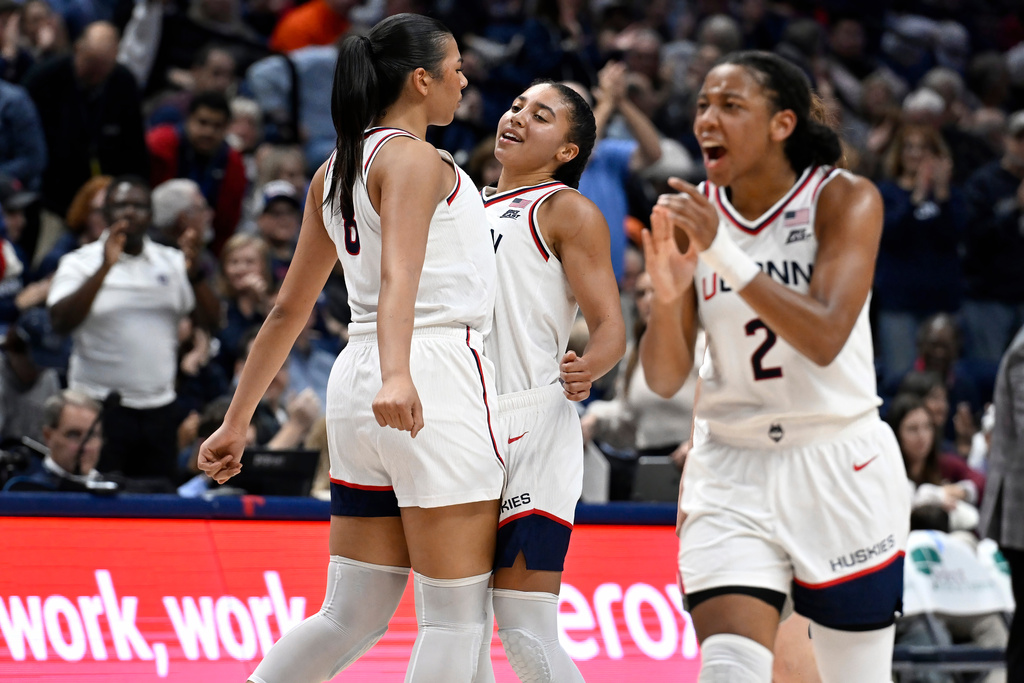 UConn center Jana el Alfy, left, chest-bumps with guard Azzi Fudd in the first half of an NCAA college basketball game against Florida State, Sunday, Nov. 9, 2025, in Storrs, Conn. (AP Photo/Jessica Hill)