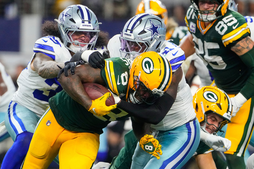 Green Bay Packers' Josh Jacobs (8) is stopped after a short gain by Dallas Cowboys defensive end Donovan Ezeiruaku (41) in the second half of an NFL football game Sunday, Sept. 28, 2025, in Arlington, Texas. (AP Photo/Jeffrey McWhorter) Green Bay Packers' Josh Jacobs (8) is stopped after a short gain by Dallas Cowboys defensive end Donovan Ezeiruaku (41) in the second half of an NFL football game Sunday, Sept. 28, 2025, in Arlington, Texas. (AP Photo/Jeffrey McWhorter)