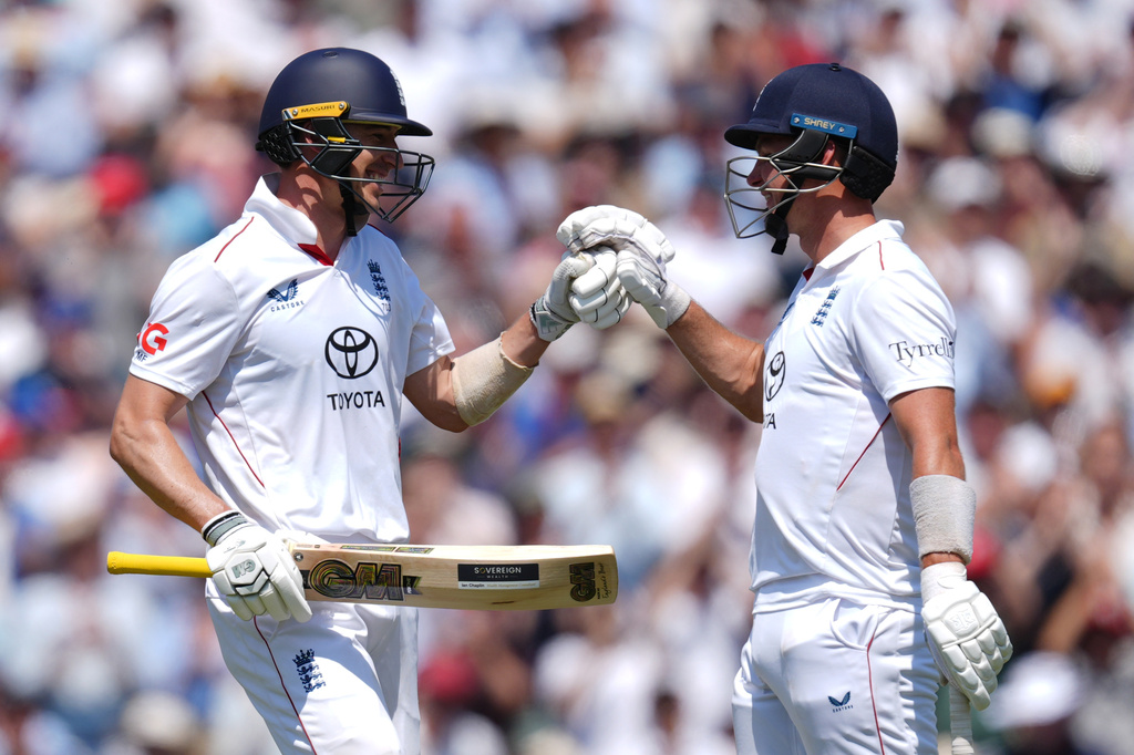 England's Matt Fisher (left) celebrates with batting partner Sonny Baker after reaching 50 runs on day three of the second cricket test between England and New Zealand, in London, Friday June 19, 2026. (Ben Whitley/PA via AP)