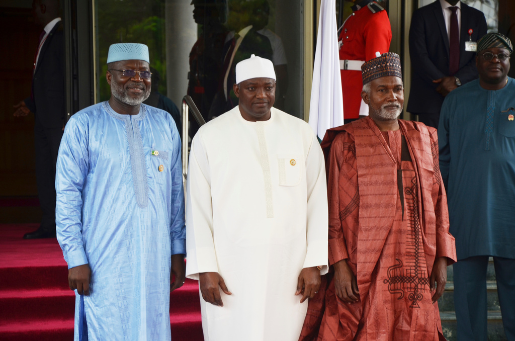 FILE - Omar Touray, president of the ECOWAS Commission, left, Gambia's President Adama Barrow,, center and Nigeria Minister of Foreign Affairs, Yusuf Tuggar pose for a photo, prior to the start of the ECOWAS meeting in Abuja, Nigeria, Sunday, June 22, 2025. (AP Photo/Olamikan Gbemiga, file)