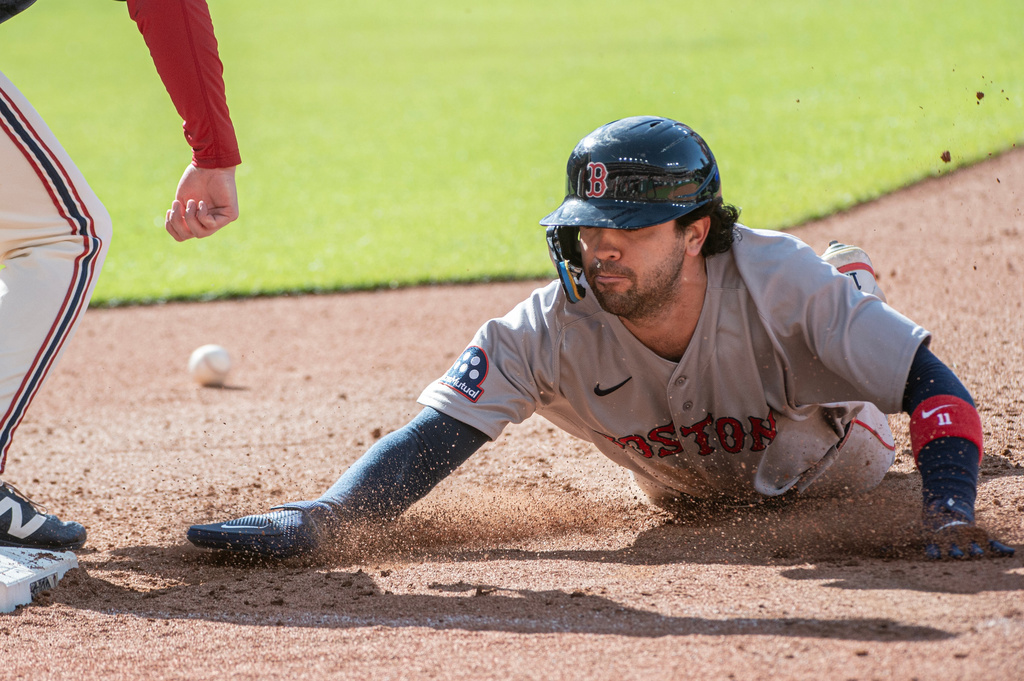 Boston Red Sox' Marcelo Mayer dives safely back to first base then takes second on a bad throw by Cleveland Guardians relief pitcher Matt Festa during the sixth inning of a baseball game, Saturday, May 30, 2026, in Cleveland. (AP Photo/Phil Long)