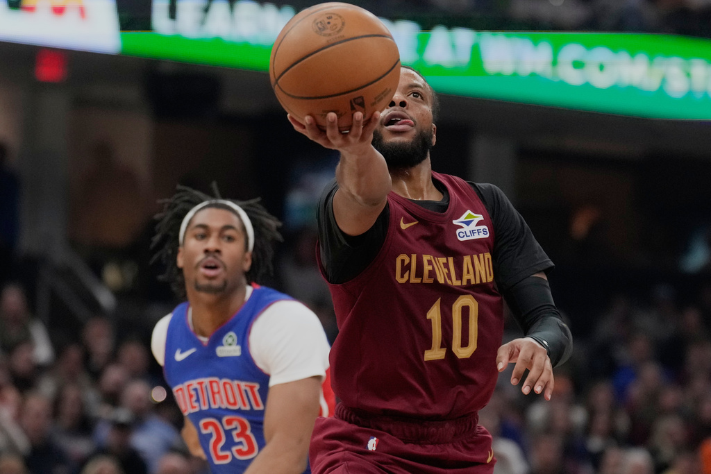 Cleveland Cavaliers guard Darius Garland (10) goes to the basket in front of Detroit Pistons guard Jaden Ivey (23) in the first half of an NBA basketball game Sunday, Jan. 4, 2026, in Cleveland. (AP Photo/Sue Ogrocki)