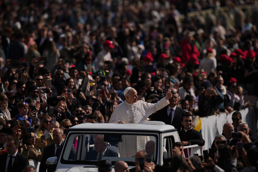 Pope Leo XIV greets faithful as he arrives in St. Peter's Square for the weekly general audience at the Vatican, Wednesday, March 25, 2026. (AP Photo/Alessandra Tarantino)