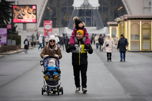 FILE - A couple and their children walk through the Exhibition of the Achievements of the People's Economy in Moscow, Russia, Thursday, Feb. 13, 2025. (AP Photo/Alexander Zemlianichenko, File) FILE - A couple and their children walk through the Exhibition of the Achievements of the People's Economy in Moscow, Russia, Thursday, Feb. 13, 2025. (AP Photo/Alexander Zemlianichenko, File)