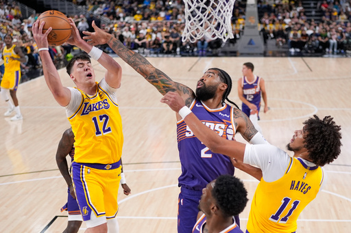 Los Angeles Lakers forward Jake LaRavia, left, grabs a rebound away from Phoenix Suns center Nick Richards, center, as center Jaxson Hayes reaches in during the first half of an NBA preseason basketball game Friday, Oct. 3, 2025, in Palm Desert, Calif. (AP Photo/Mark J. Terrill) Los Angeles Lakers forward Jake LaRavia, left, grabs a rebound away from Phoenix Suns center Nick Richards, center, as center Jaxson Hayes reaches in during the first half of an NBA preseason basketball game Friday, Oct. 3, 2025, in Palm Desert, Calif. (AP Photo/Mark J. Terrill)