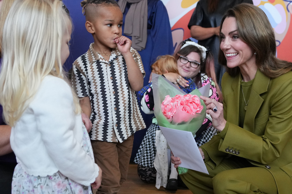 Kate, Princess of Wales receives a posey as she visits Home-Start Oxford to meet and talk to families, and the volunteers who support them, in Oxford, England, Thursday, Oct. 9, 2025. (AP Photo/Kirsty Wigglesworth, Pool)