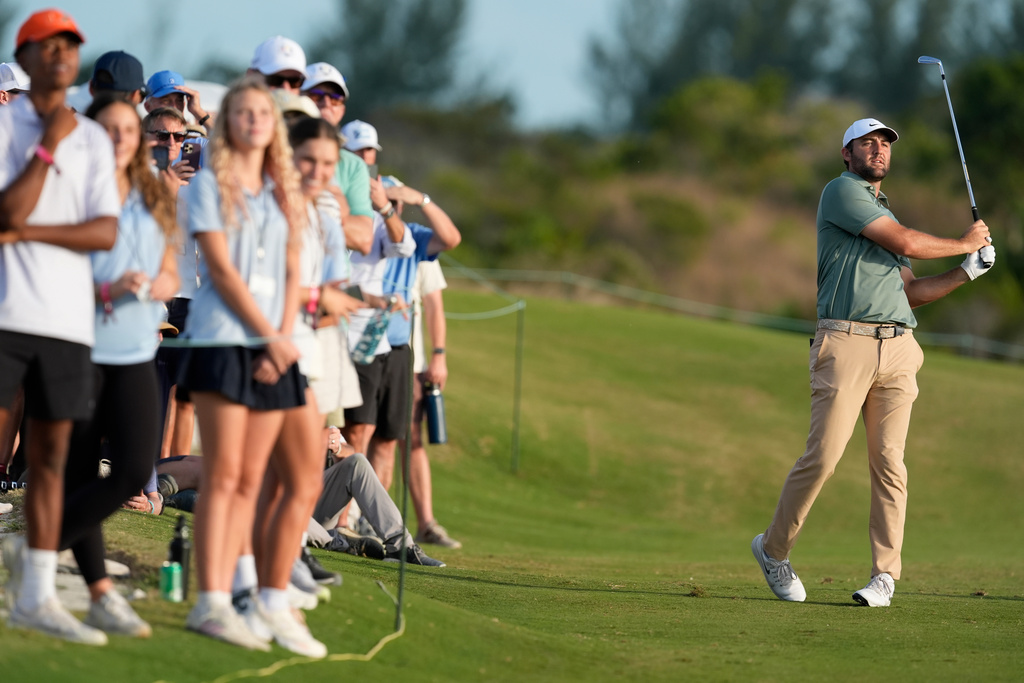 Scottie Scheffler, of the United States, watches his shot from the 18th fairway during the first round of the Hero World Challenge PGA Tour at the Albany Golf Club, in New Providence, Bahamas, Thursday, Dec. 4, 2025. (AP Photo/Fernando Llano)