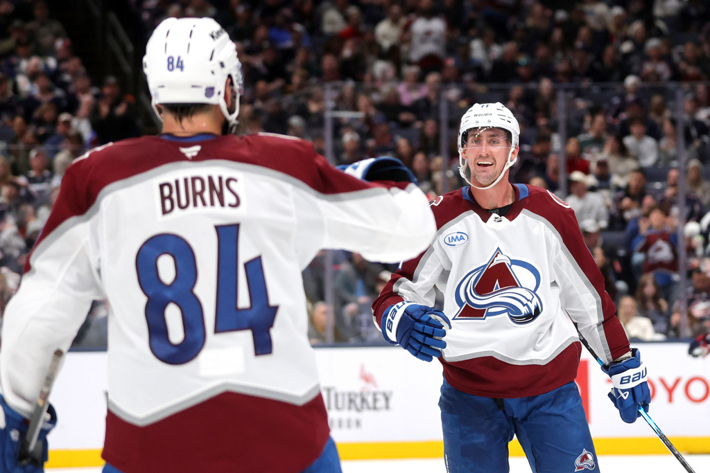 Colorado Avalanche forward Brock Nelson, right, celebrates with teammate defenseman Brent Burns after Burns goal against the Columbus Blue Jackets during the second period of an NHL hockey game in Columbus, Ohio, Thursday, Oct. 16, 2025. (AP Photo/Paul Vernon)
