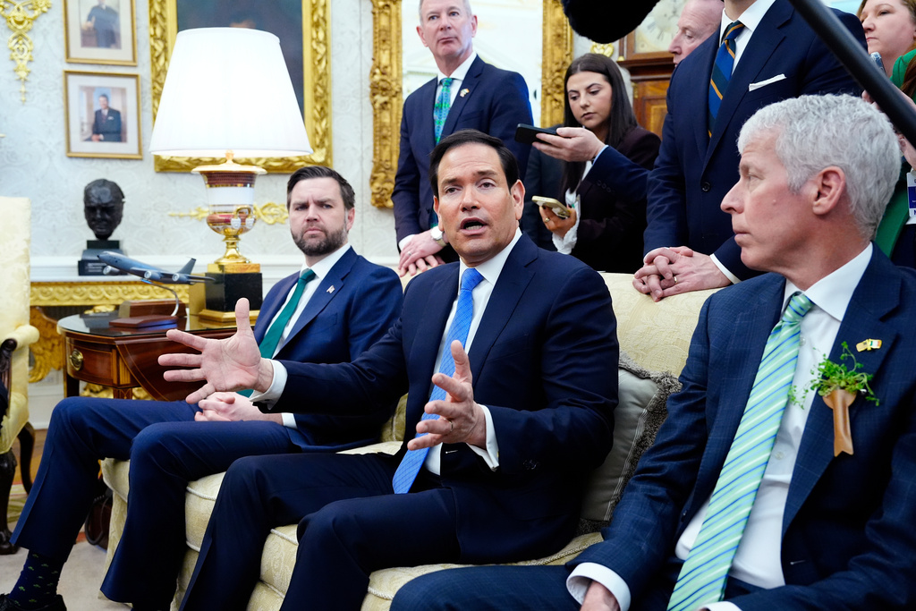 Secretary of State Marco Rubio answers a question about Cuba during a meeting between President Donald Trump and Irish Prime Minister Micheál Martin in the Oval Office of the White House, on St. Patrick's Day, Tuesday, March 17, 2026, in Washington. (AP Photo/Alex Brandon)