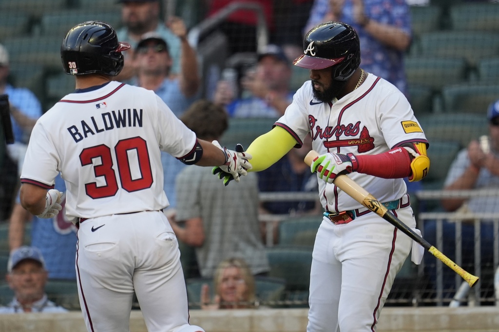 Atlanta Braves' Drake Baldwin (30) celebrates with Marcell Ozuna after hitting a solo home run against the Miami Marlins in the first inning of a baseball game, Thursday, Aug. 7, 2025, in Atlanta. (AP Photo/Mike Stewart)