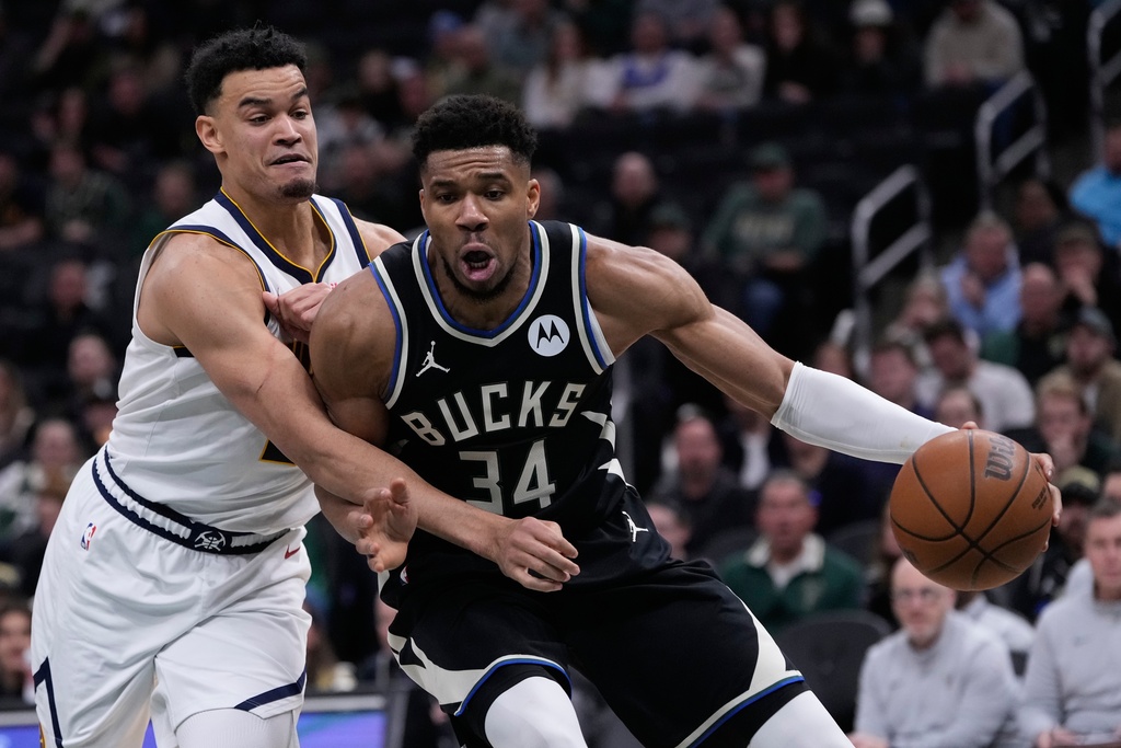 Milwaukee Bucks' Giannis Antetokounmpo (34) tries to get past Denver Nuggets' Spencer Jones during the second half of an NBA basketball game Friday, Jan. 23, 2026, in Milwaukee. (AP Photo/Morry Gash)