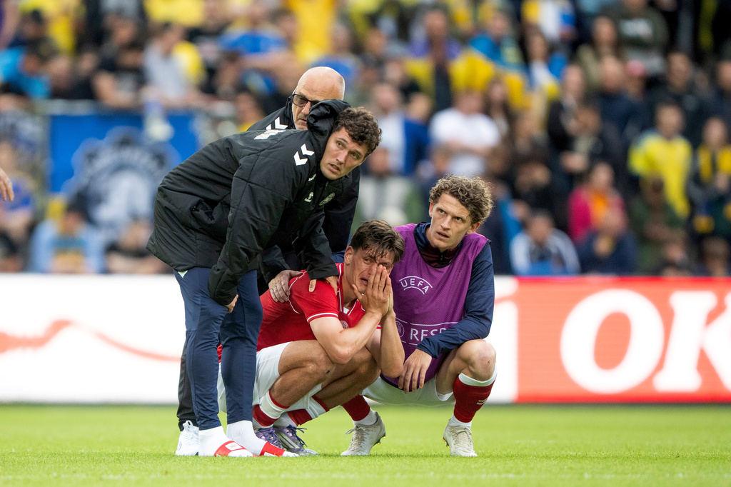 Denmark's Joakim Maehle, Andreas Christensen, and Jens Stage react after Christian Eriksen collapsed on the field during the international friendly soccer match between Denmark and Ukraine in Odense, Denmark, Sunday, June 7, 2026. (Bo Amstrup/Ritzau Scanpix via AP)