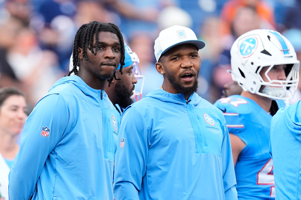Tennessee Titans quarterback Cam Ward, left, and running back Tony Pollard look on as teammates warm up prior to a preseason NFL football game against the Chicago Bears, Saturday, Aug. 29, 2026, in Nashville, Tenn. (AP Photo/George Walker IV)