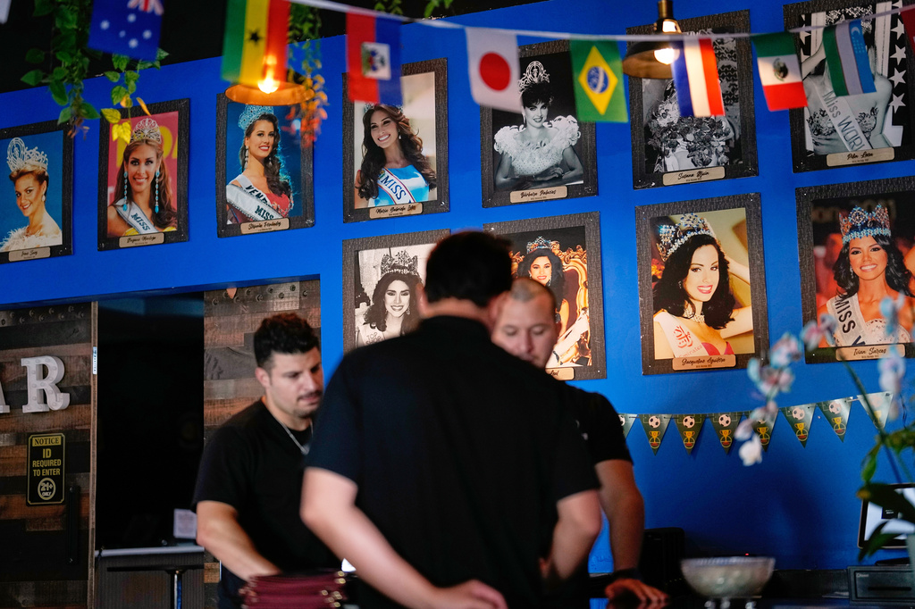 Photos of Venezuelan Miss Universe contestants line a wall at Arempa's restaurant Tuesday, July 14, 2026, in Midvale, Utah. (AP Photo/Gregory Bull)