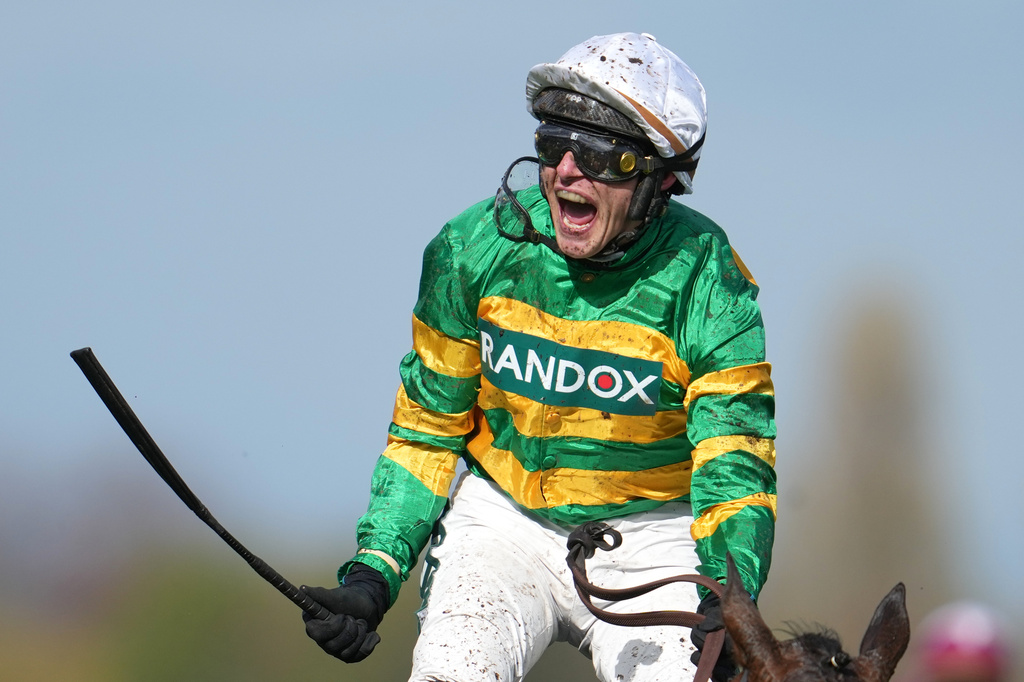 Jockey Paul Townend celebrates on I Am Maximus after winning the Grand National horse race at Aintree racecourse in Liverpool, Saturday, April 11, 2026. (AP Photo/Jon Super)