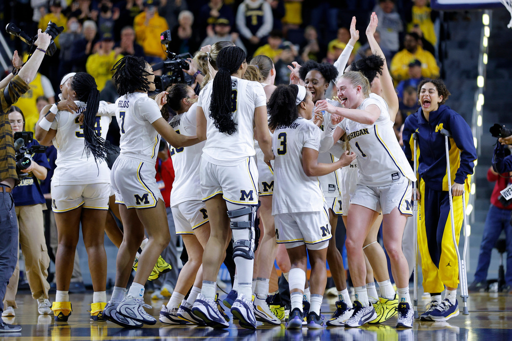 Michigan players celebrate after defeating North Carolina State in the second round of the NCAA college basketball tournament, Sunday, March 22, 2026, in Ann Arbor, Mich. (AP Photo/Al Goldis)