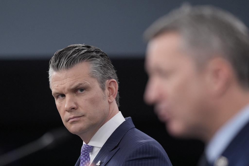 Defense Secretary Pete Hegseth looks over as Chairman of the Joint Chiefs of Staff Gen. Dan Caine speaks to members of the media during a press briefing at the Pentagon in Washington, Tuesday, March 31, 2026. (AP Photo/Manuel Balce Ceneta)