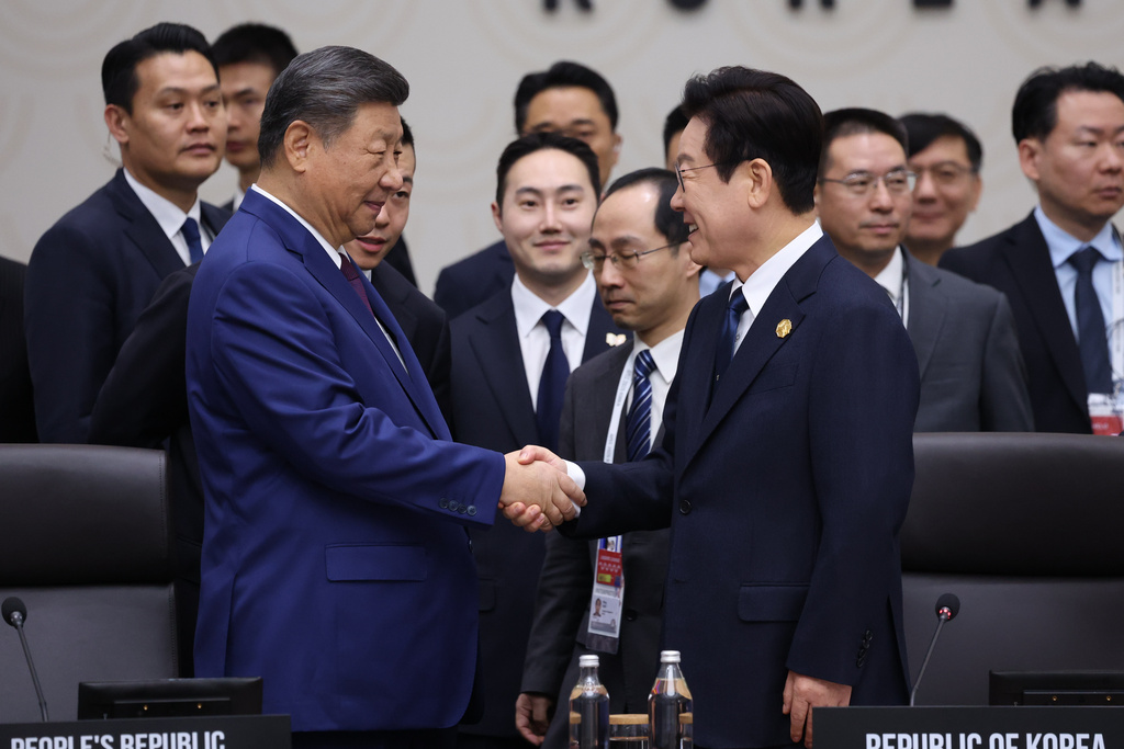 South Korean President Lee Jae Myung, right, shakes hands with Chinese President Xi Jinping at the Asia-Pacific Economic Cooperation (APEC) Economic Leaders' Meeting in Gyeongju, South Korea, Saturday, Nov. 1, 2025. (Yonhap via AP)