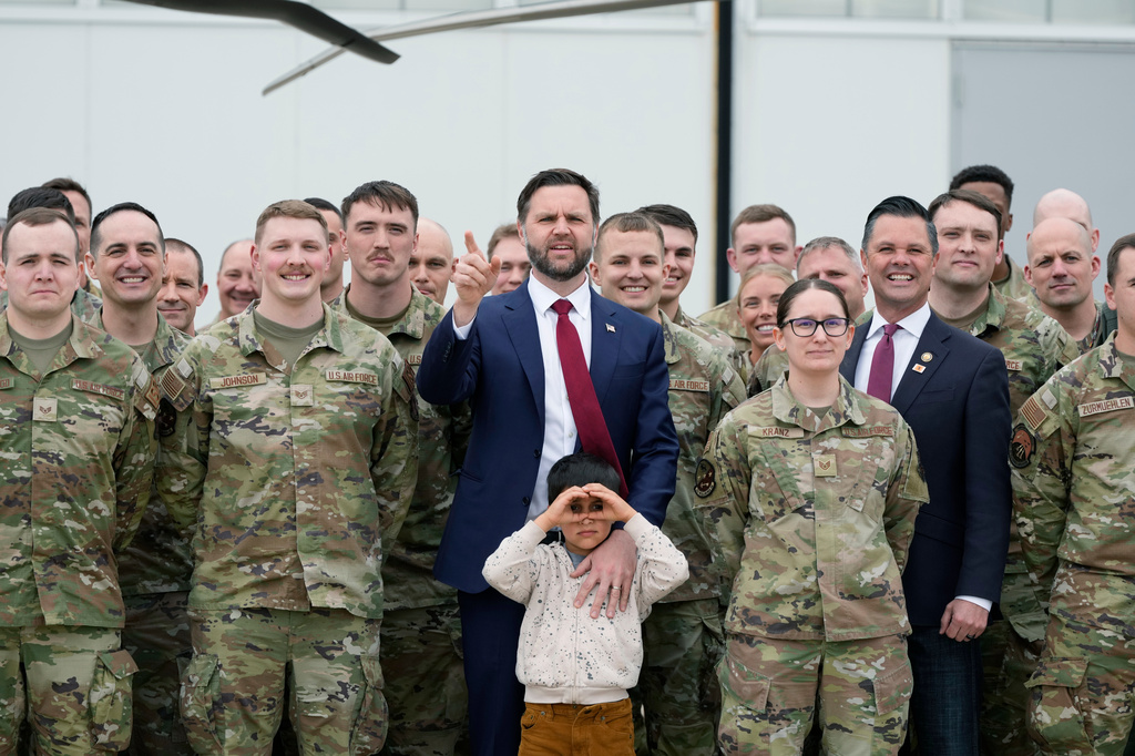 Vice President JD Vance, accompanied by his son Vivek, and Rep. Zach Nunn, R-Iowa, poses for a photo with members of Iowa Army and Air National Guard at Des Moines International Airport in Des Moines, Iowa, Tuesday, May 5, 2026. (AP Photo/Charlie Neibergall)