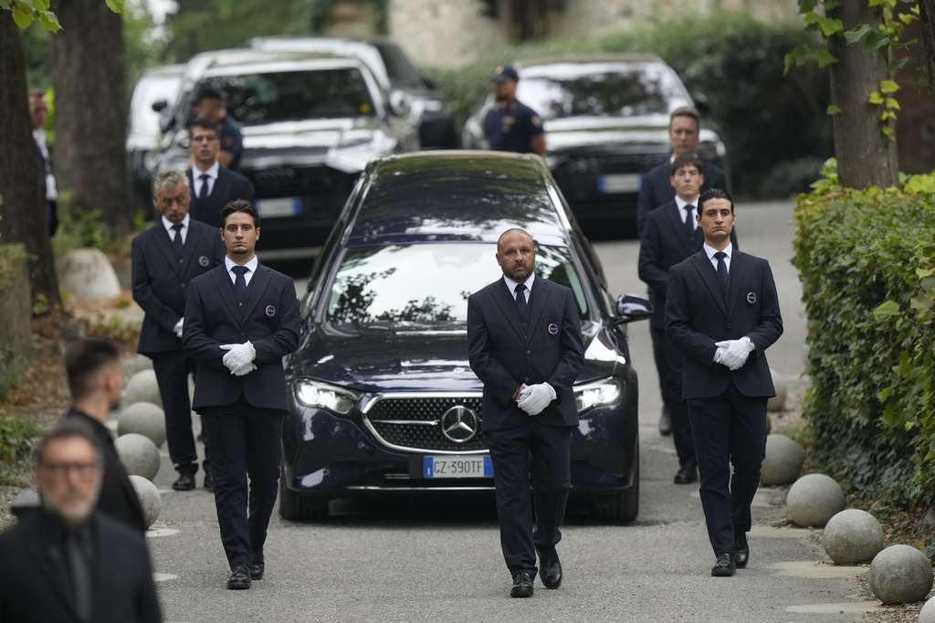 The hearse leaves at the end of designer Giorgio Armani's funeral in the San Martino church in the small historic village of Rivalta, some 15 kilometers south of Piacenza, northern Italy, Monday, Sept. 8, 2025. (AP Photo/Luca Bruno)