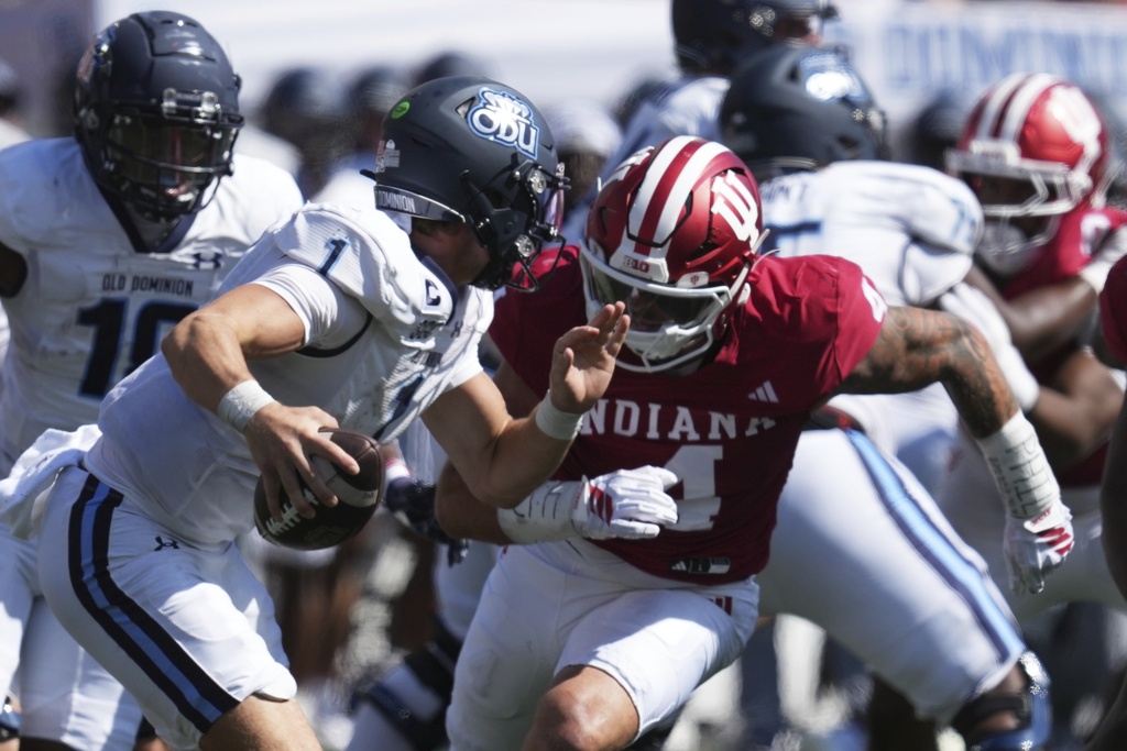 Old Dominion quarterback Colton Joseph (1) is chased by Indiana linebacker Aiden Fisher (4) during the first half of an NCAA college football game, Saturday, Aug. 30, 2025, in Bloomington, Ind. (AP Photo/Darron Cummings)