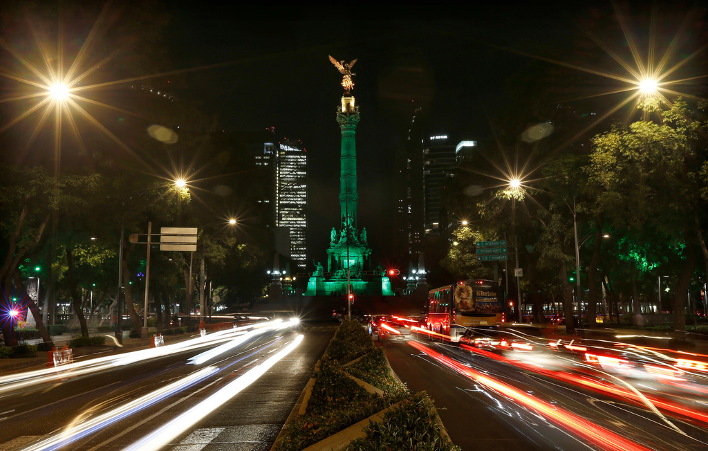 FILE - Cars drive past the Angel of Independence monument in Mexico City, June 1, 2017. (AP Photo/Marco Ugarte, File)