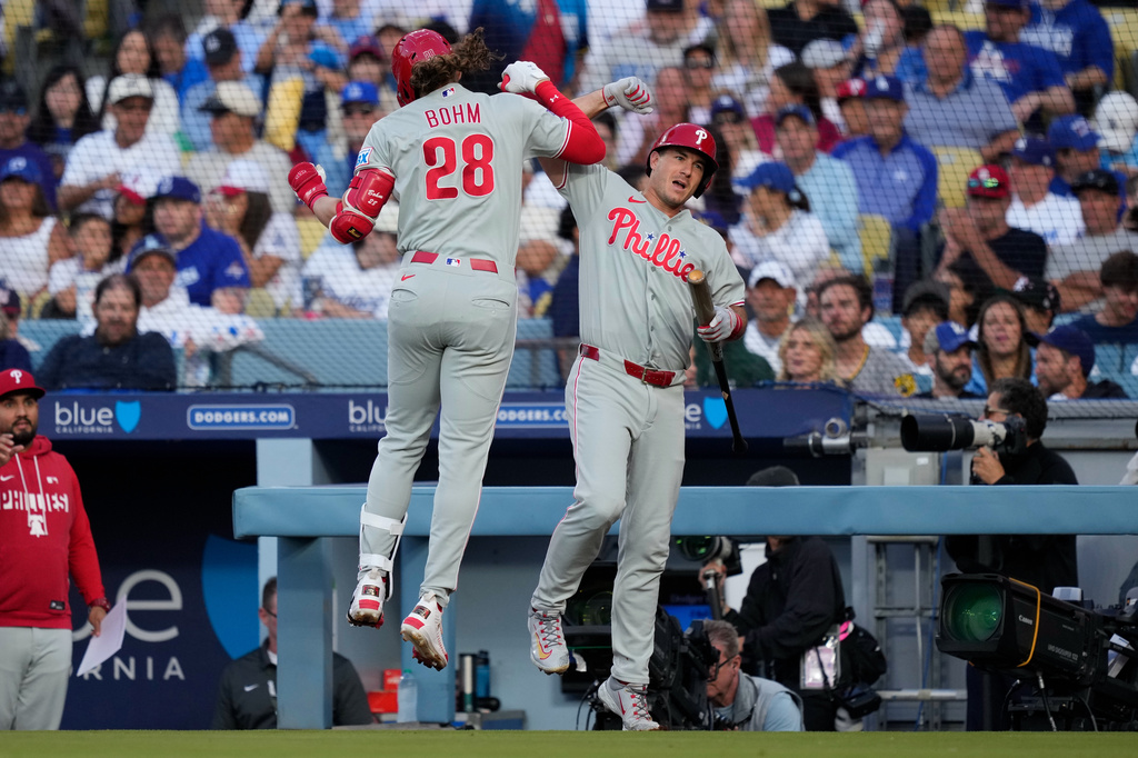 Philadelphia Phillies' Alec Bohm, left, celebrates his solo home run with J.T. Realmuto, during the second inning of a baseball game against the Los Angeles Dodgers, Saturday, May 30, 2026, in Los Angeles. (AP Photo/Mark J. Terrill)