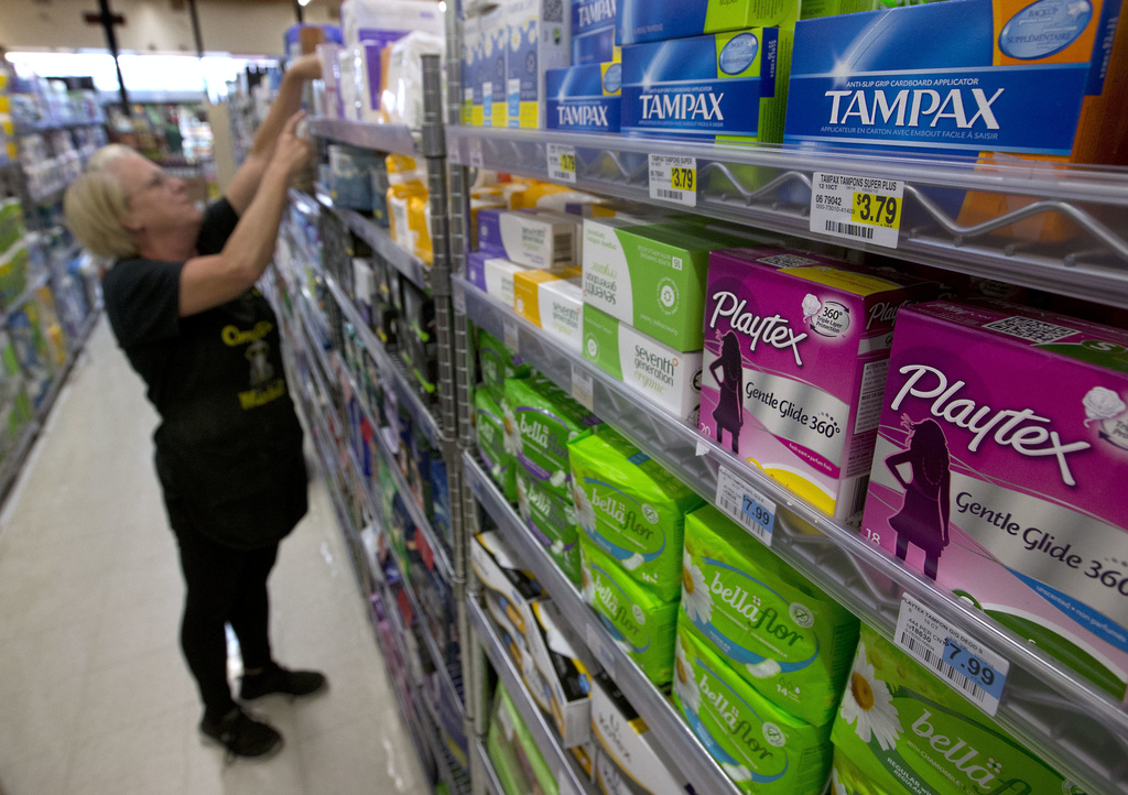 FILE - Tammy Compton restocks tampons at Compton's Market, in Sacramento, Calif., June 22, 2016. (AP Photo/Rich Pedroncelli, File)