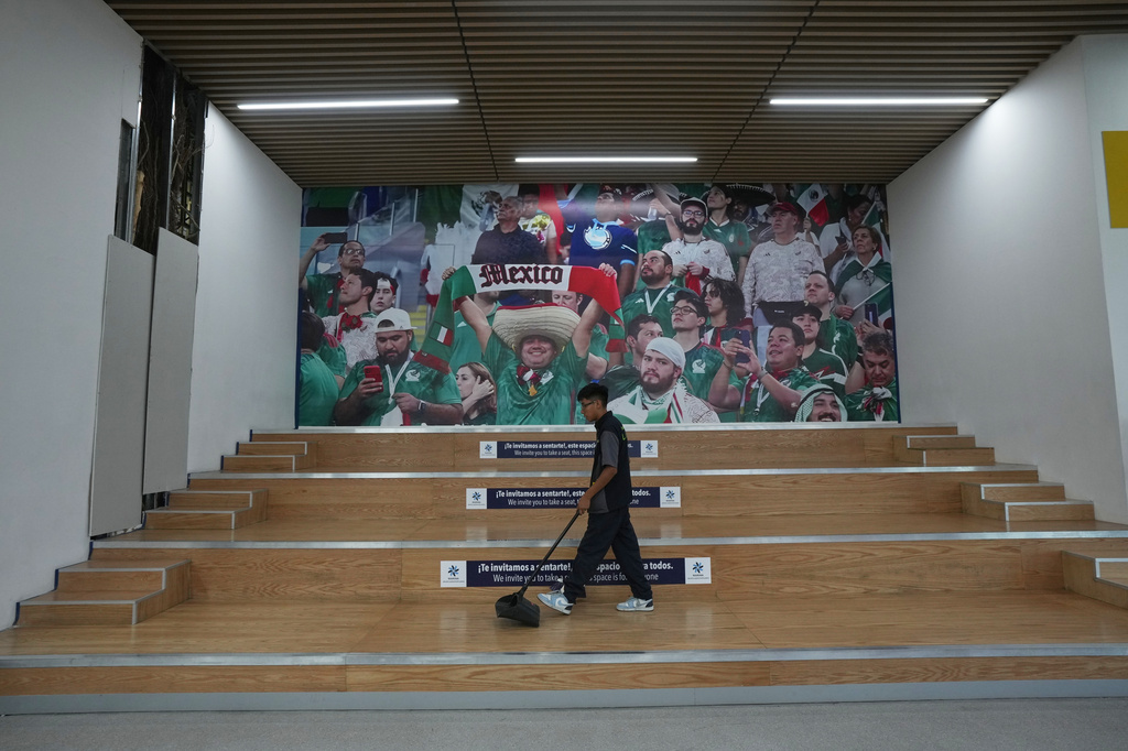 An employee cleans the waiting area in Terminal 2 during a guided media tour of the renovation work at Benito Juárez International Airport, in preparation for the 2026 World Cup in Mexico City, on Tuesday, May 19, 2026. (AP Photo/Fernando Llano)