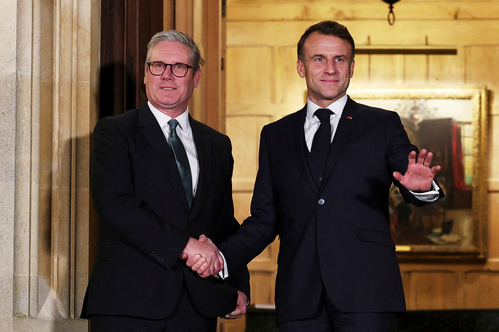 FILE - British Prime Minister Keir Starmer, left, and French President Emmanuel Macron shake hands ahead of a bilateral meeting at Chequers, near Aylesbury, England, Jan. 9, 2025. (Toby Melville/Pool Photo via AP, File)