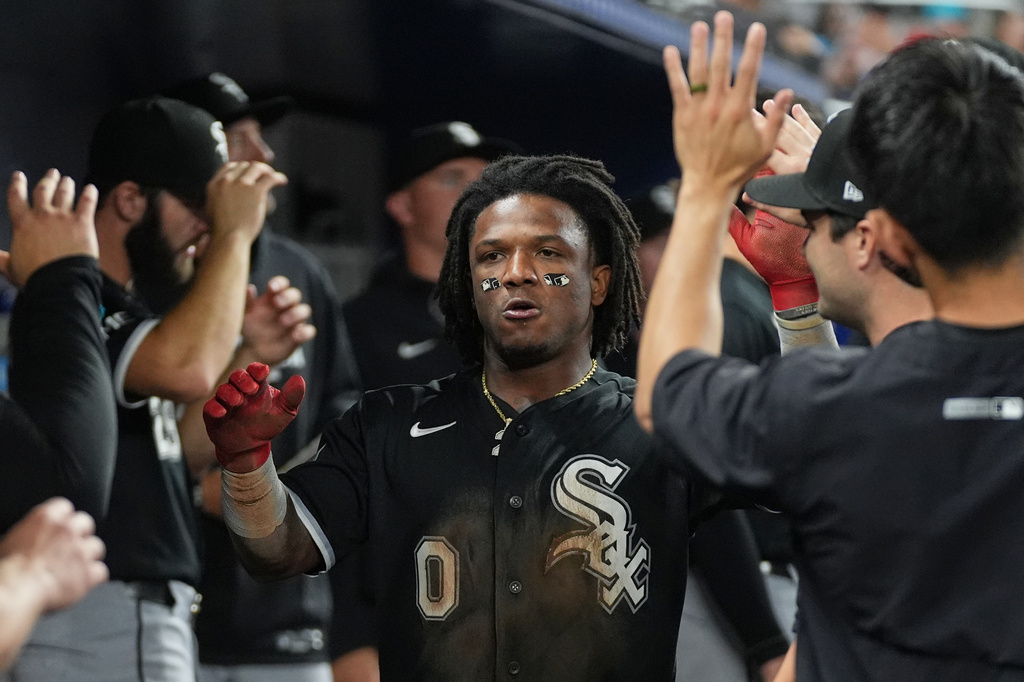 Chicago White Sox Luisangel Acuna (0) celebrates after scoring in the sixth inning during a baseball game against the Miami Marlins Monday, March 30, 2026, in Miami. (AP Photo/Marta Lavandier)