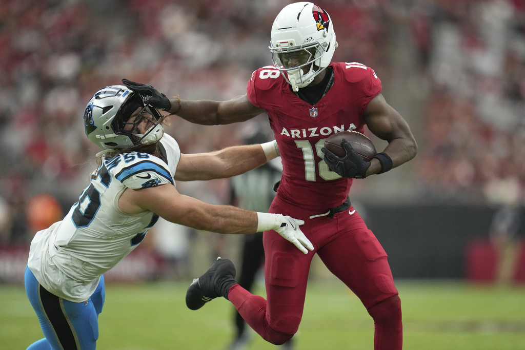 Arizona Cardinals wide receiver Marvin Harrison Jr. (18) stiff-arms Carolina Panthers linebacker Christian Rozeboom (56) after the catch during the second half of an NFL football game, Sunday, Sept. 14, 2025, in Glendale, Ariz. (AP Photo/Rick Scuteri)