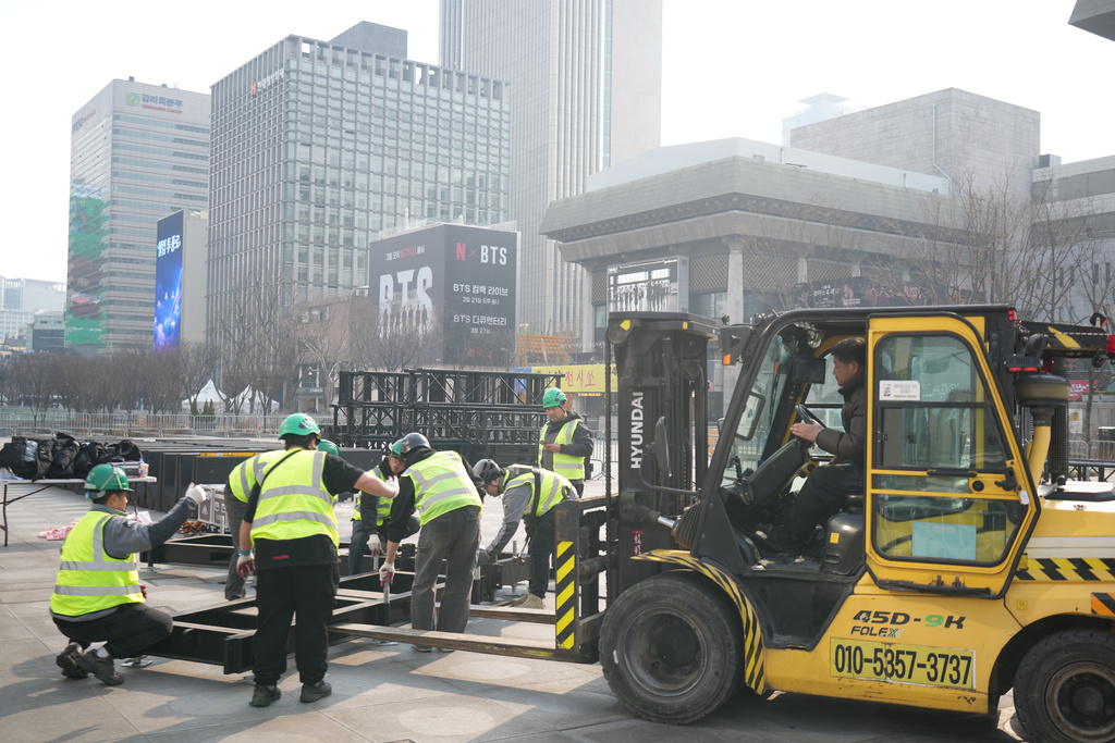 Workers prepare for a concert by K-pop group BTS at Gwanghwamun Square in Seoul, South Korea, Monday, March 16, 2026. (AP Photo/Lee Jin-man)