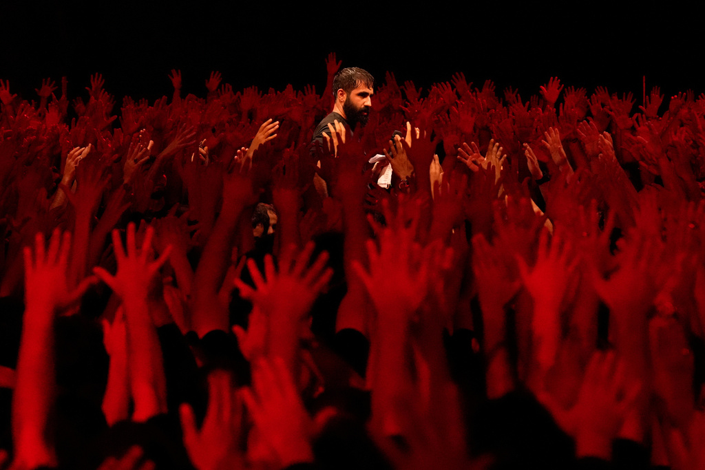Iranian Shiite Muslims mourn in a ceremony on the eve of Ashoura, the death anniversary of Prophet Muhammad's grandson, Hussein, in Tehran Iran, July 5, 2025, (AP Photo/Vahid Salemi, File)