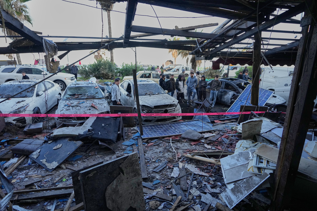 People check the damage of a coffeeshop at the site of an Israeli strike in the southern port city of Sidon, Lebanon, Wednesday, April, 8, 2026. (AP Photo/Mohammed Zaatari)