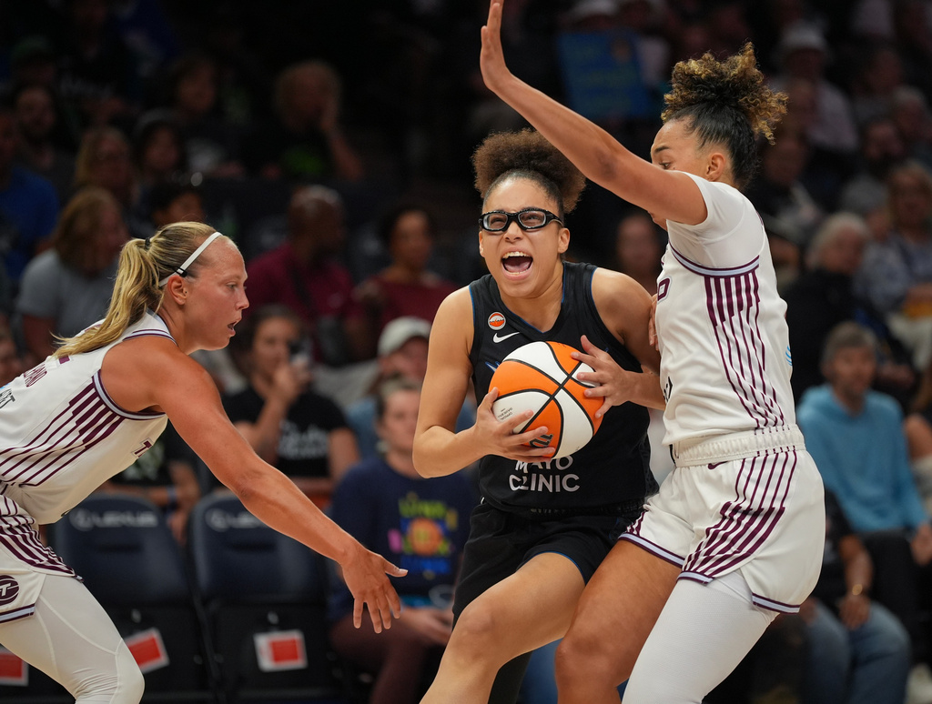 Minnesota Lynx guard Olivia Miles (5) drives around Toronto Tempo guards Kiki Rice (1) and Julie Allemand (22), left, in the first quarter of a WNBA basketball game Tuesday, July 28, 2026, in Minneapolis. (Jeff Wheeler/Minnesota Star Tribune via AP)