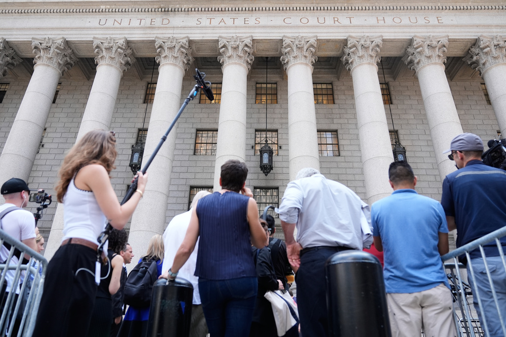 Reporters and others wait outside of a federal courthouse during a hearing for Luigi Mangione in New York, Monday, June 29, 2026. (AP Photo/Seth Wenig)