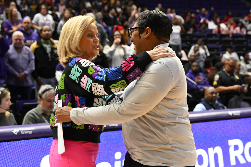LSU head coach Kim Mulkey, left, and Morgan State head coach Nadine Domond, right, greet each other before an NCAA college basketball game, Tuesday, Dec. 16, 2025, in Baton Rouge, La. (AP Photo/Ella Hall)