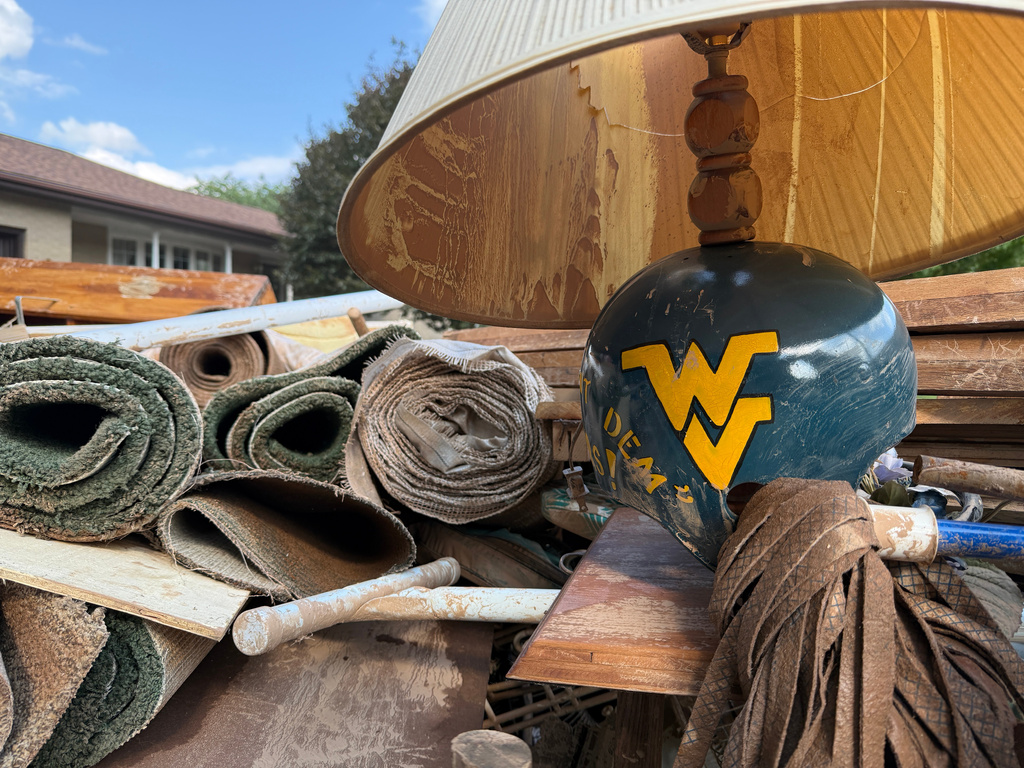 Damage and debris outside of a home after severe floods in Weston, W.Va., on Wednesday, July 22, 2026. (AP Photo/Patrick Aftoora-Orsagos)