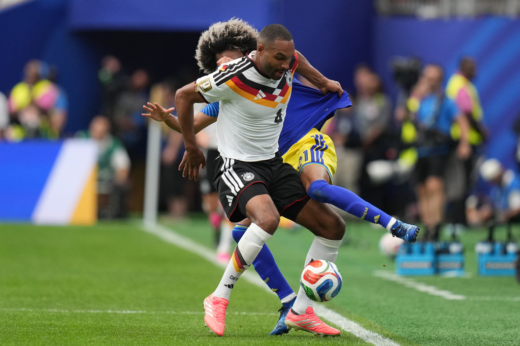 Germany's Jonathan Tah, front , and Curaçao's Tahith Chong fight for the ball during the World Cup Group E soccer match between Germany and Curacao in Houston, Sunday, June 14, 2026. (AP Photo/Eric Gay)