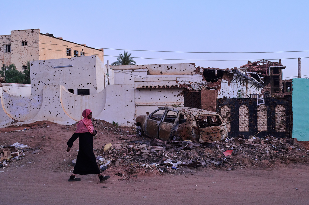 A woman walks along a street in Omdurman, Sudan, on the outskirts of Khartoum, Friday, April 17, 2026. (AP Photo/Bernat Armangue)