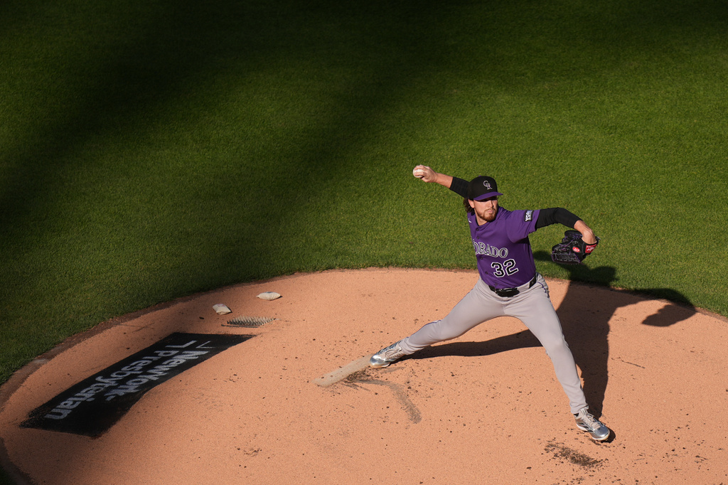 Colorado Rockies pitcher Chase Dollander throws during the first inning of the second baseball game of a doubleheader against the New York Mets, Sunday, April 26, 2026, in New York. (AP Photo/Seth Wenig)