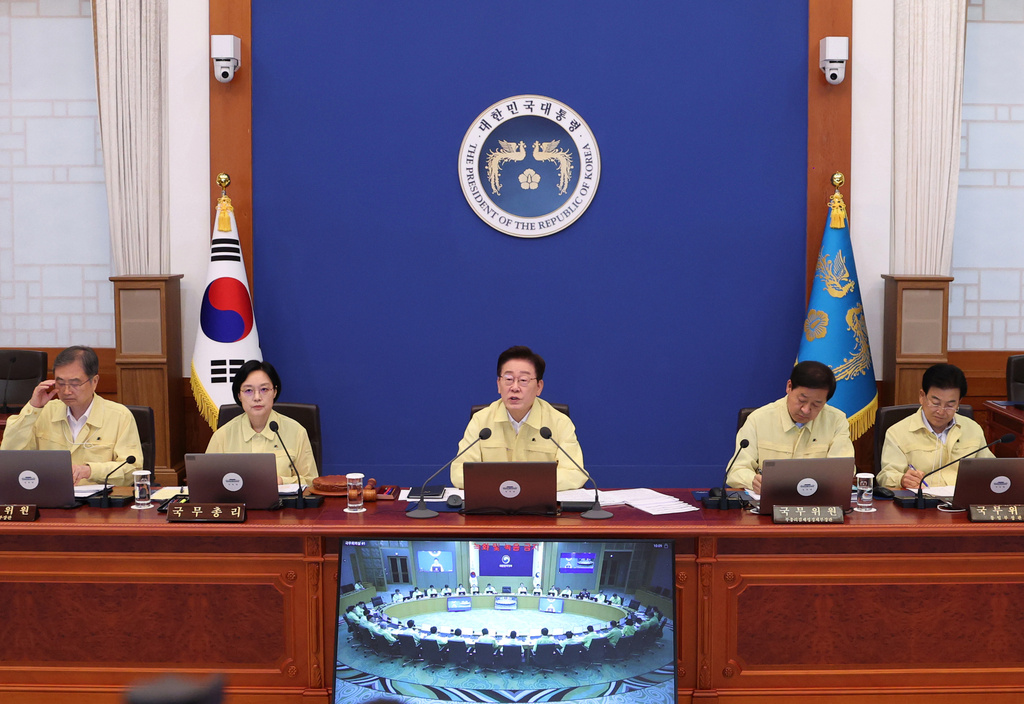 South Korean President Lee Jae Myung, center, speaks during a cabinet meeting at the presidential office in Seoul, South Korea, Tuesday, Aug. 18, 2026. (Yonhap via AP)