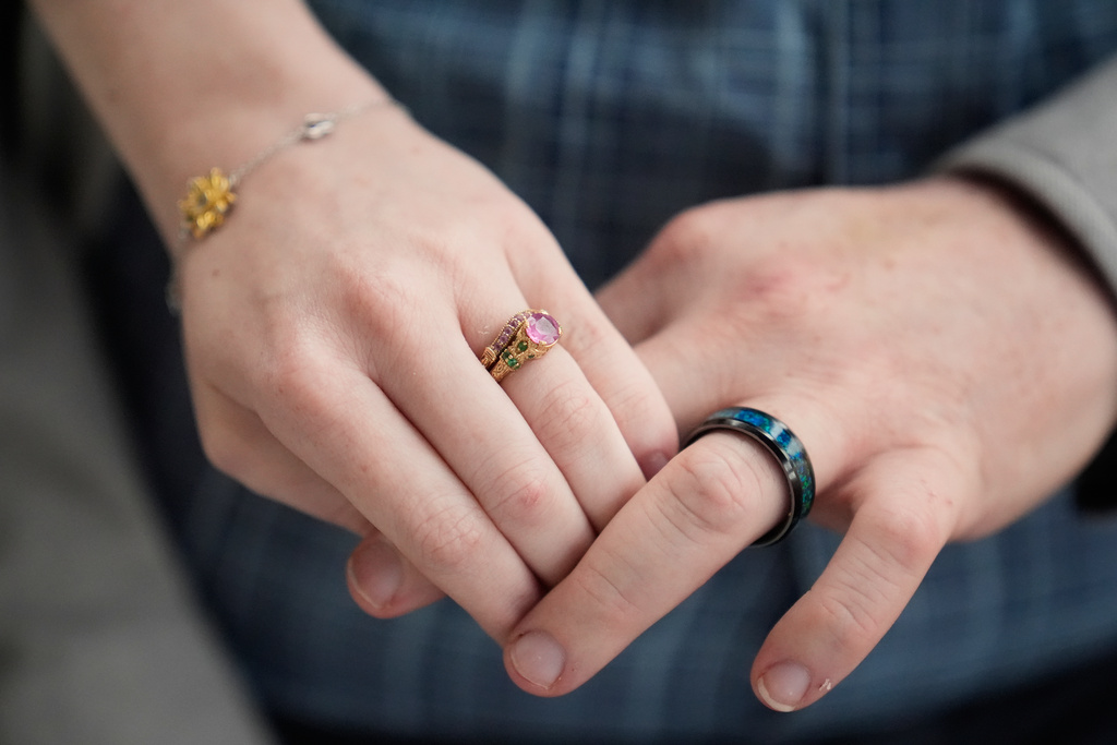 Kaci LaFon, left, and her husband Collin LaFon hold hands at their home in Trussville, Ala., on on Friday, Nov. 21, 2025. (AP Photo/Brynn Anderson)