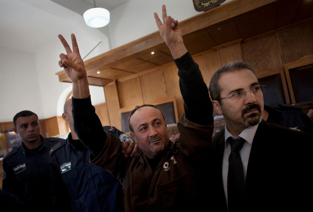 FILE - Senior Fatah leader Marwan Barghouti makes the victory sign in front of the media during his arrival to testify in a trial at a Jerusalem court, Jan. 25, 2012. (AP Photo/Bernat Armangue, File)