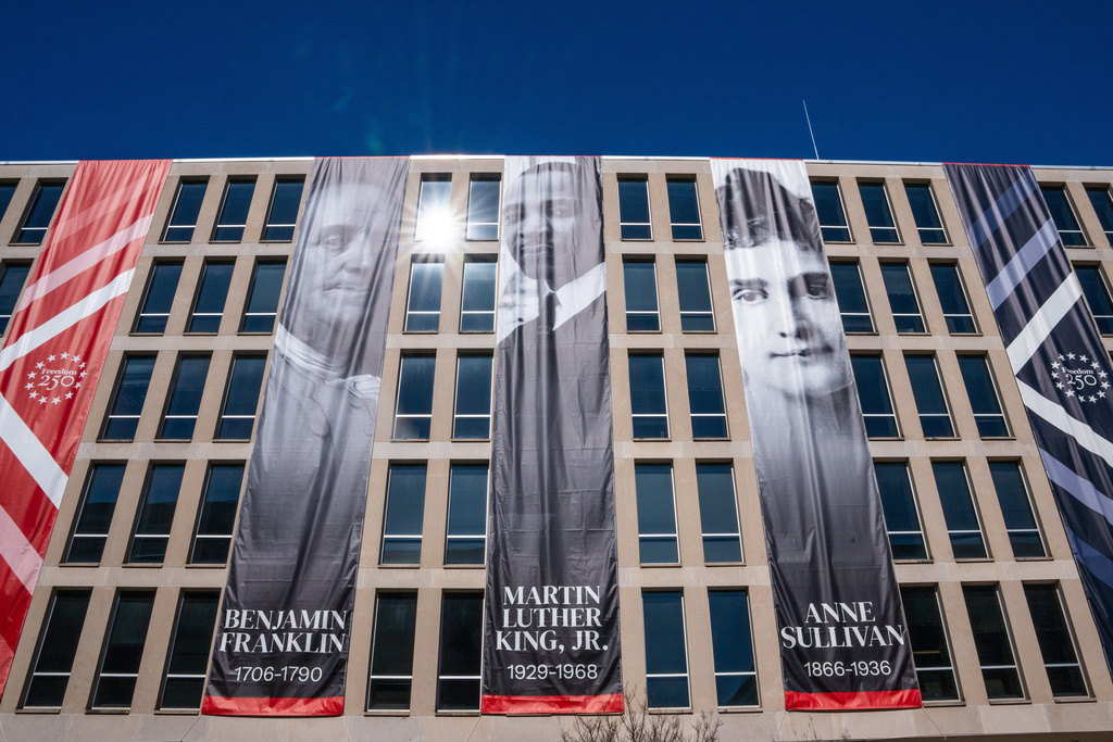 New banners of Benjamin Franklin, Martin Luther King Jr. and Anne Sullivan hang from the Department of Education, Sunday, March 1, 2026, in Washington. (AP Photo/Allison Robbert)
