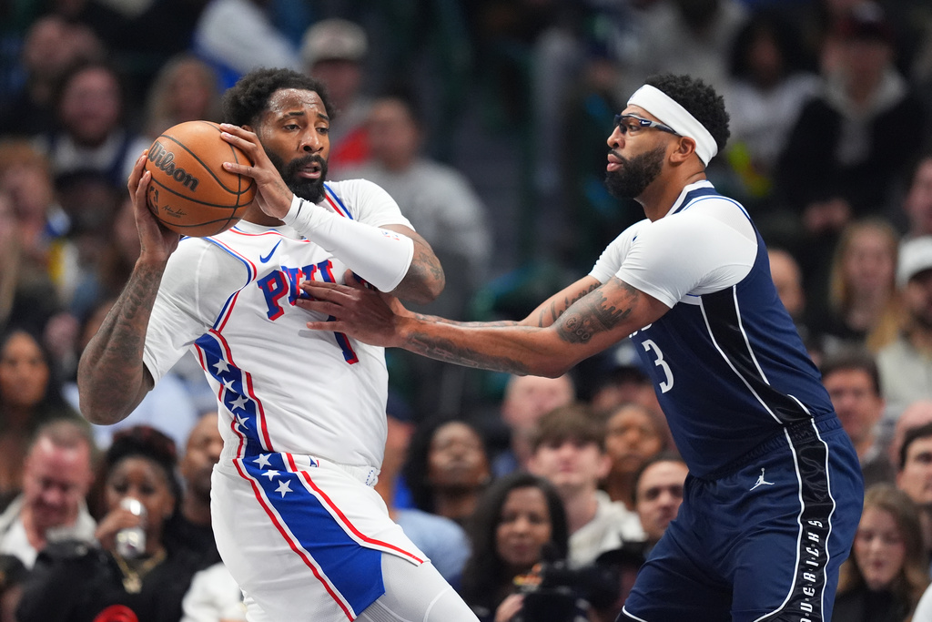 Philadelphia 76ers center Andre Drummond, left, is guarded by Dallas Mavericks forward Anthony Davis during the first half of an NBA basketball game Thursday, Jan. 1, 2026, in Dallas. (AP Photo/Julio Cortez)