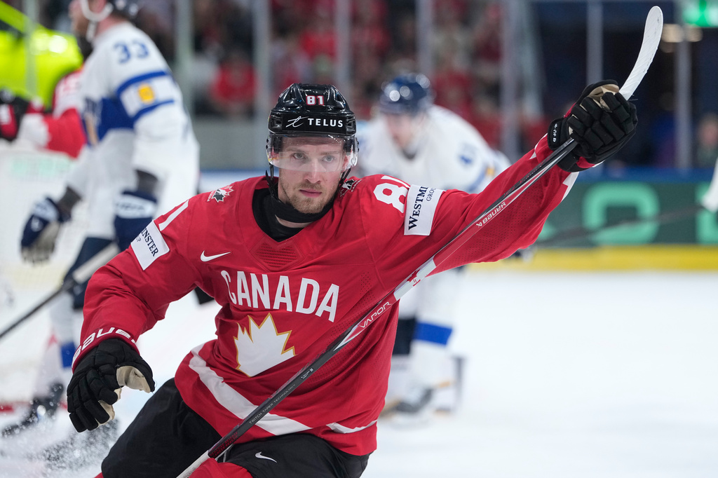 Canada's Dylan Holloway (81) celebrates after scoring his side's second goal during the 2026 IIHF Men's Ice Hockey World Championship semifinal match between Canada and Finland, in Zurich, Switzerland, Saturday, May 30, 2026, (AP Photo/Darko Bandic)
