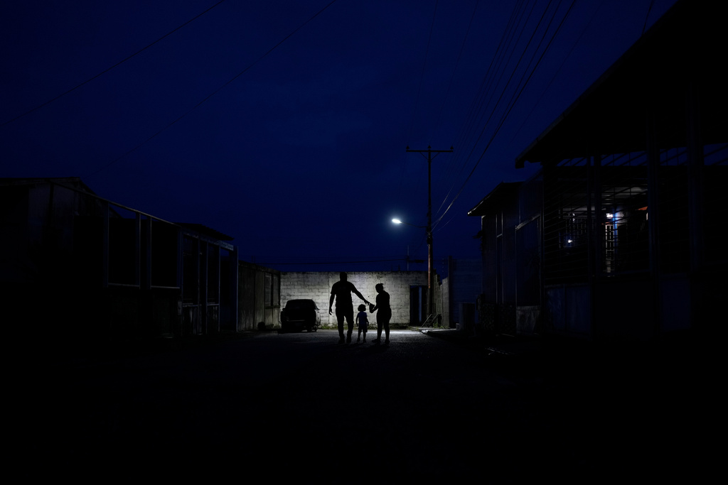 Juan Guedez, left, and his wife Gabriela Villanueva walk with their daughter in Araure, Venezuela, June 12, 2025. The couple traveled by land from Chile to Mexico, crossing the Darien Gap in an attempt to reach the U.S., but had to make their way back home after the Trump administration closed the border to asylum seekers. (AP Photo/Matias Delacroix)